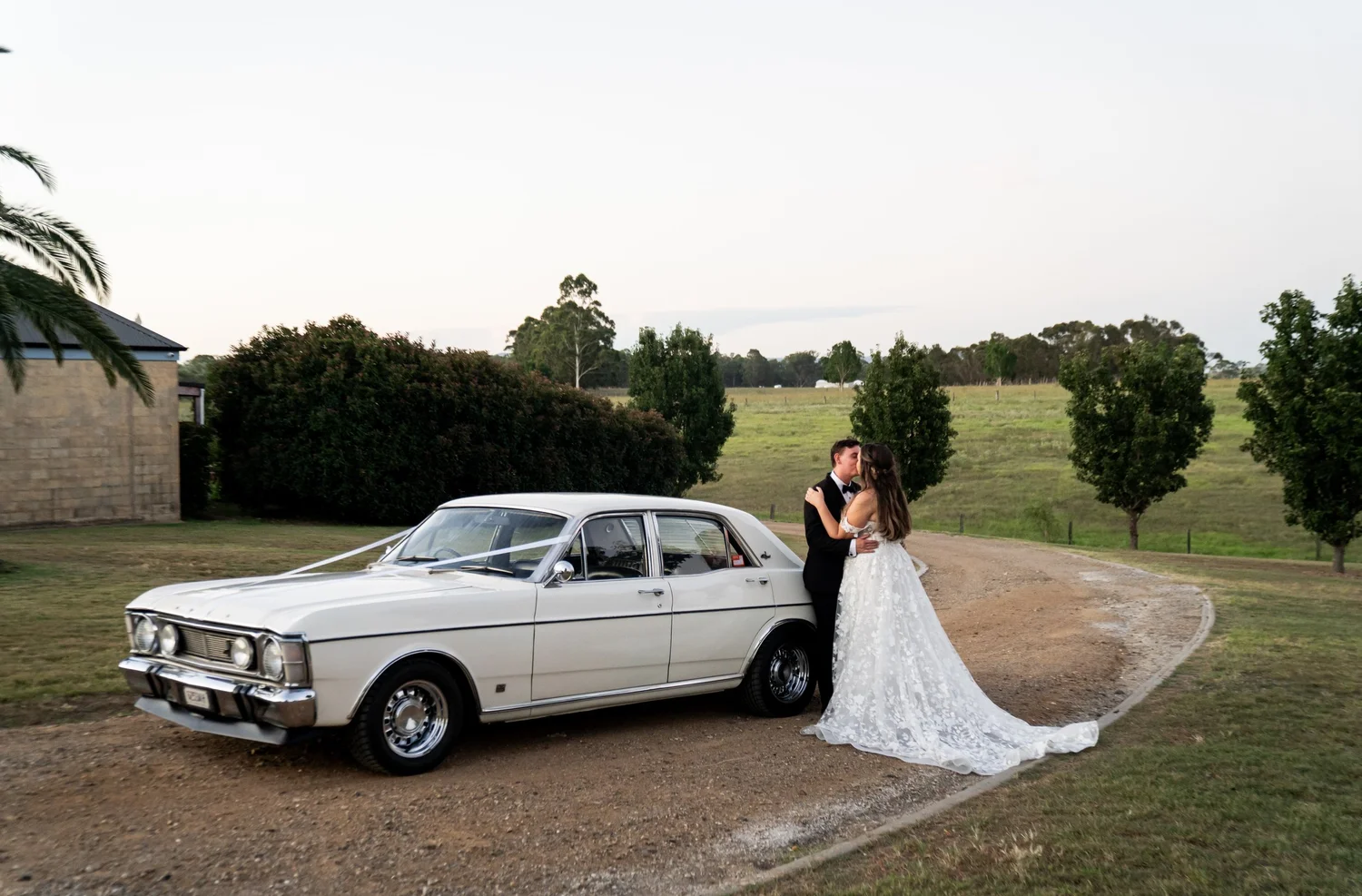 The couple with a vintage car on a country road