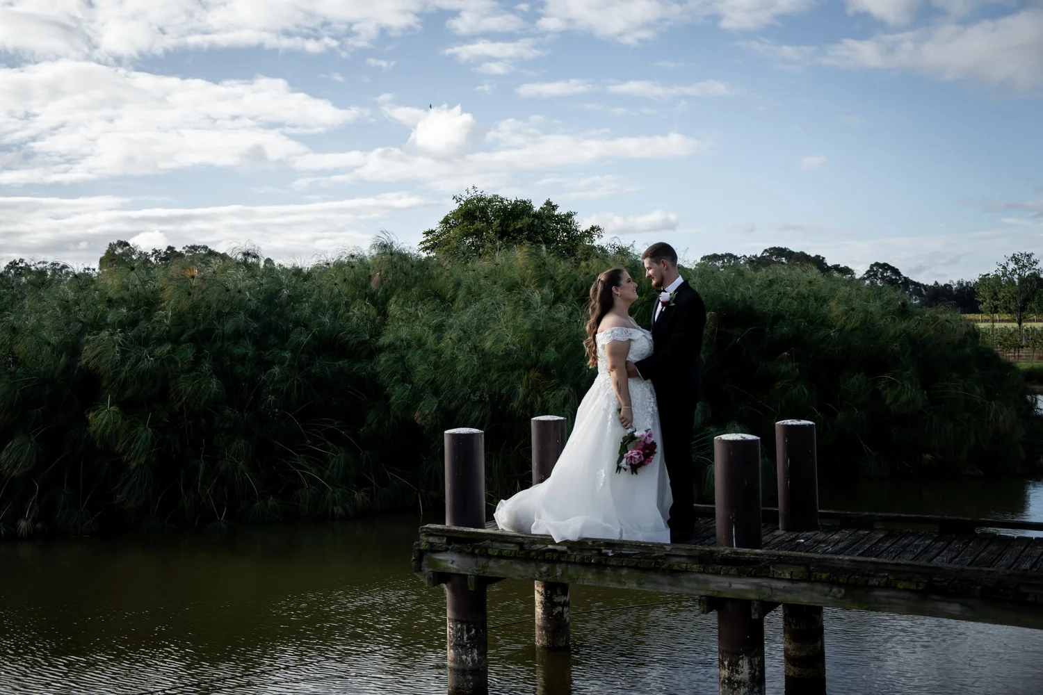 The couple on a jetty by the water