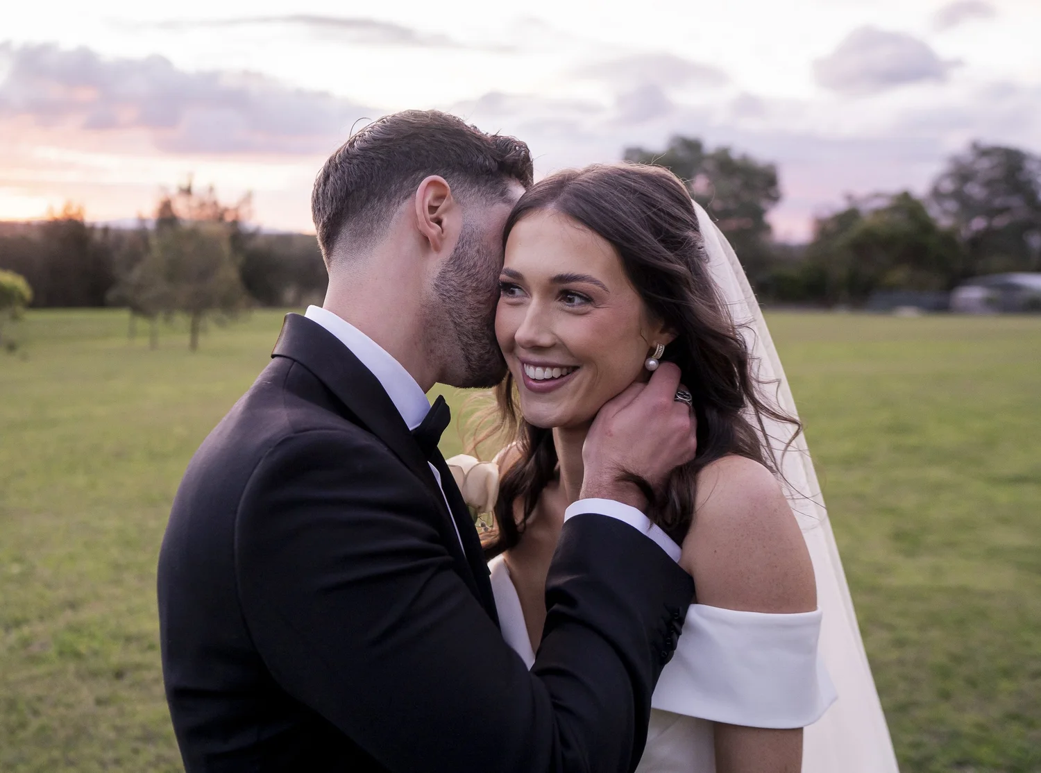 The couple close together at golden hour