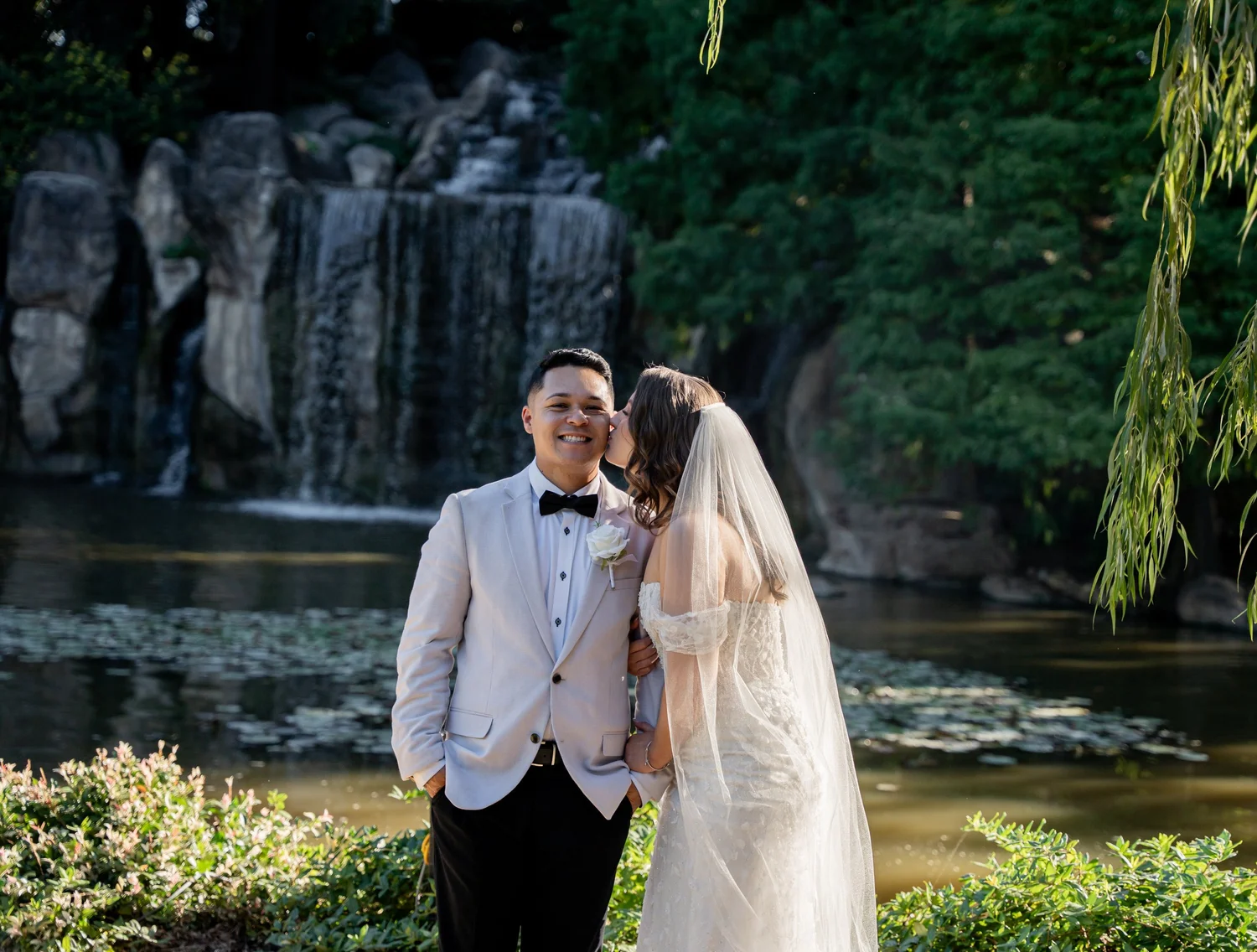 The couple in front of a waterfall in the garden