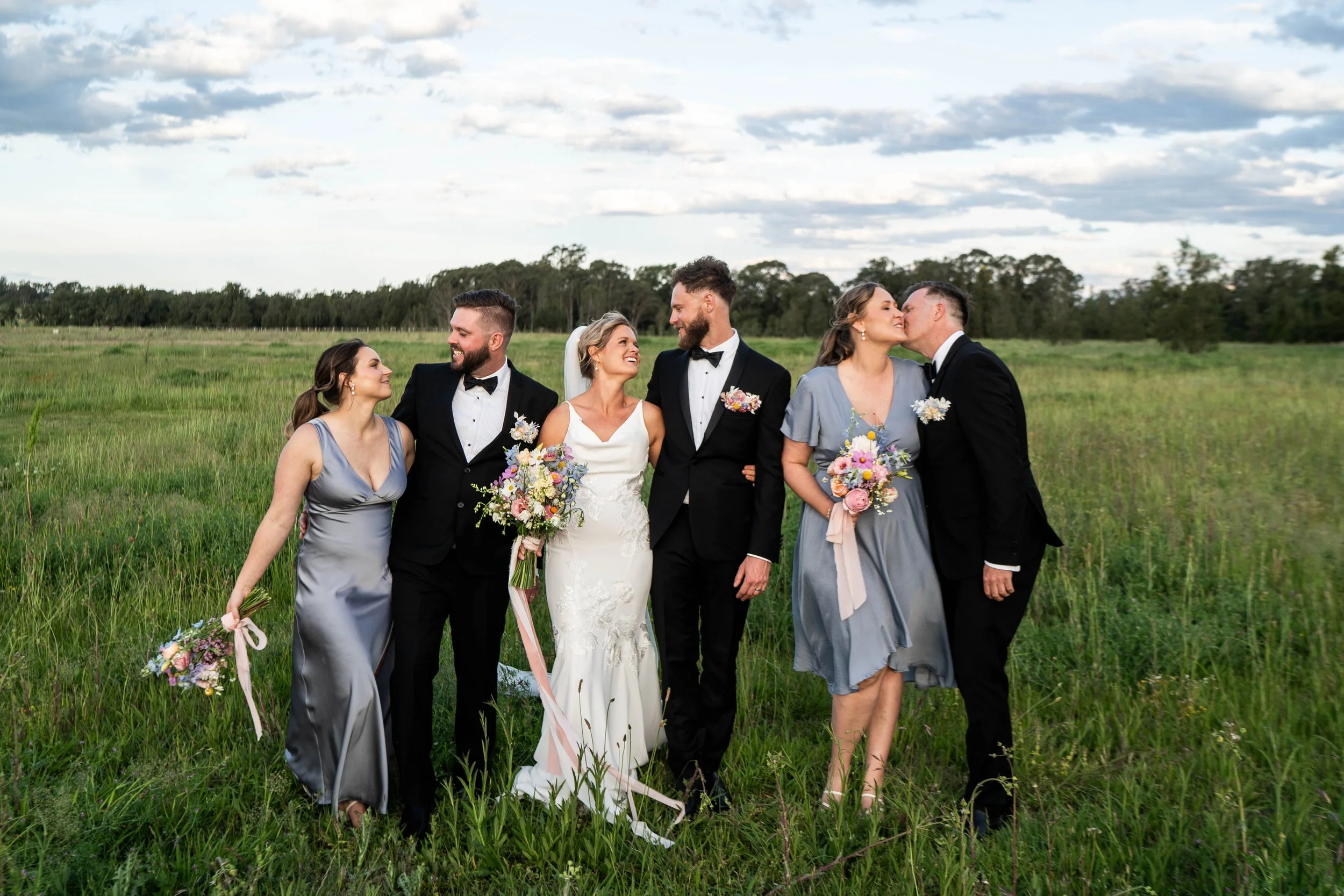 The wedding party in a green field