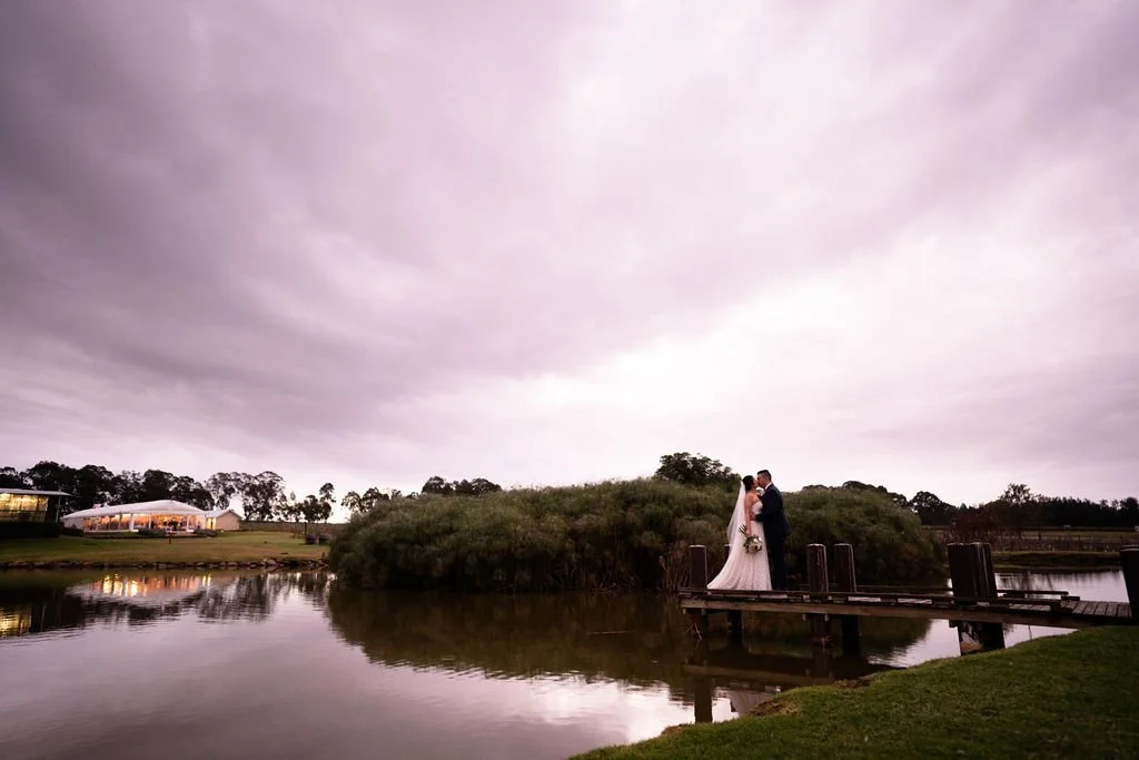 Peterson House by the lake under a pink sky. Wedding at Peterson House, Hunter Valley
