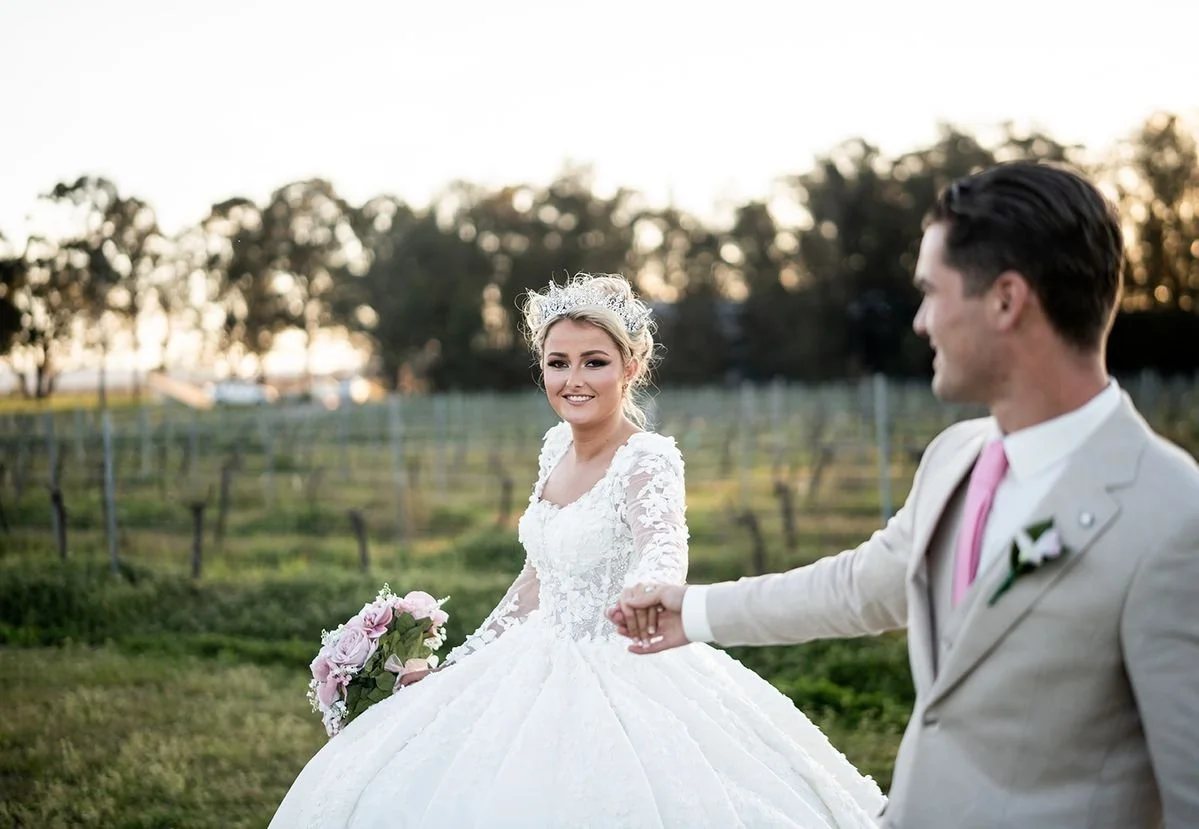 Walking through the vineyard. Wedding at Peterson House, Hunter Valley