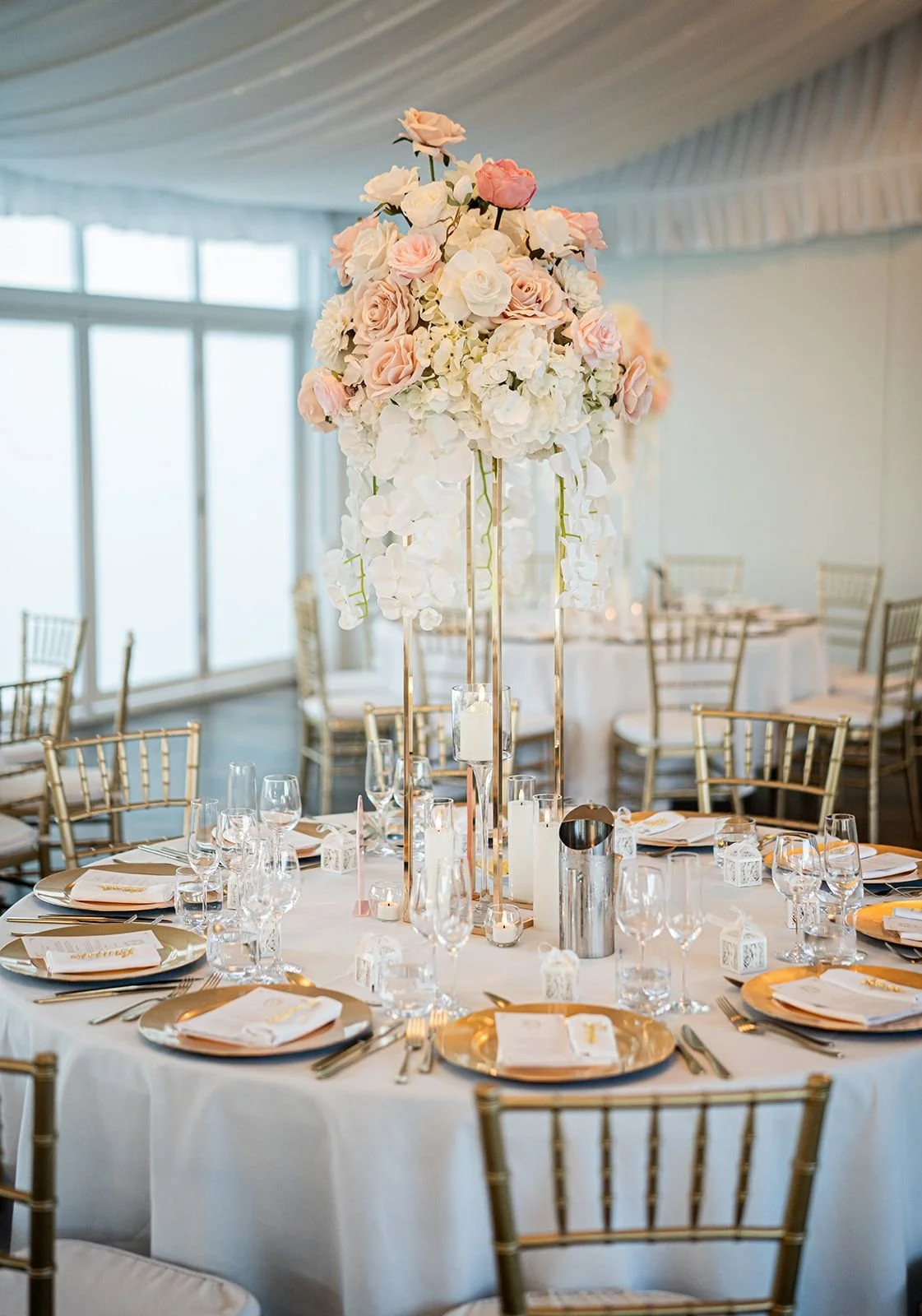 A tall floral centrepiece on the reception table. Wedding at Peterson House, Hunter Valley