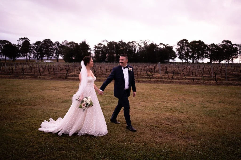 Walking across the lawn. Wedding at Peterson House, Hunter Valley