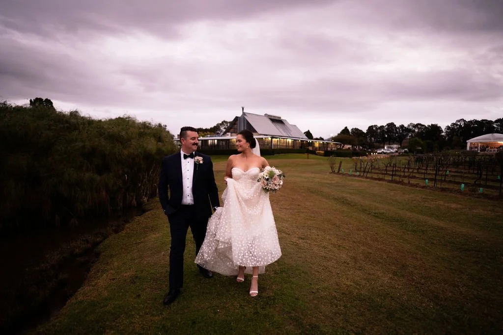Walking down a farm track. Wedding at Peterson House, Hunter Valley