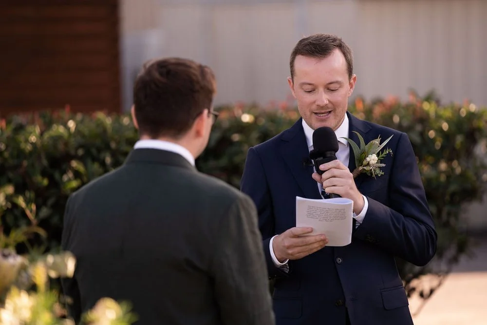 Reading vows at the ceremony. Aaron & Scott's wedding at Margan Wines, Hunter Valley