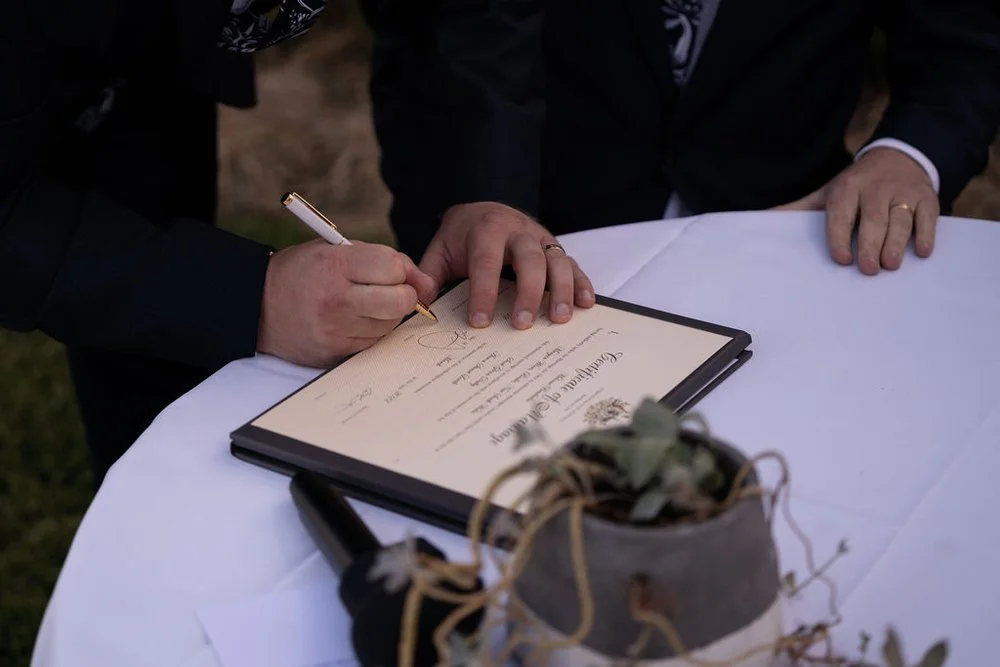 Signing the register after the ceremony. Aaron & Scott's wedding at Margan Wines, Hunter Valley