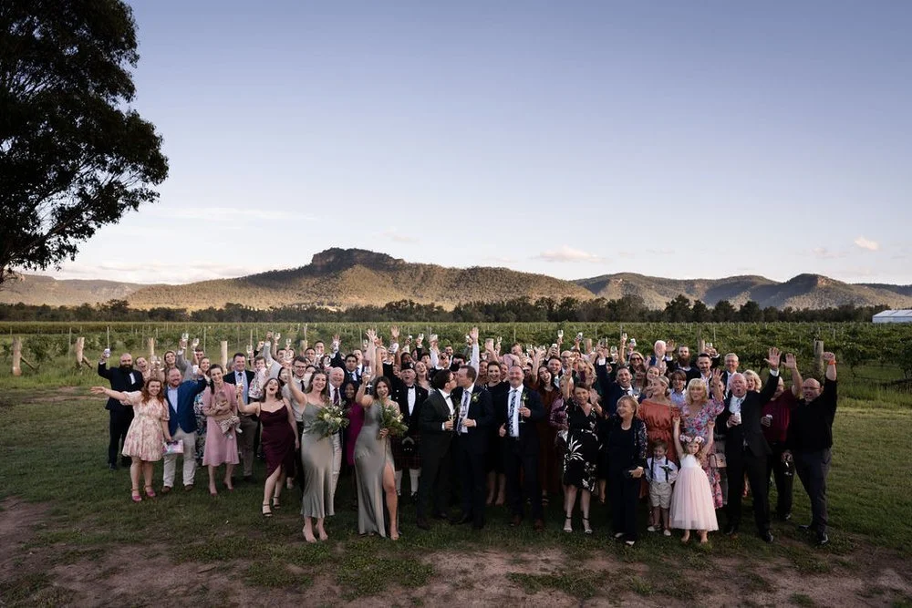 Group photo with every guest in the vineyard. Aaron & Scott's wedding at Margan Wines, Hunter Valley