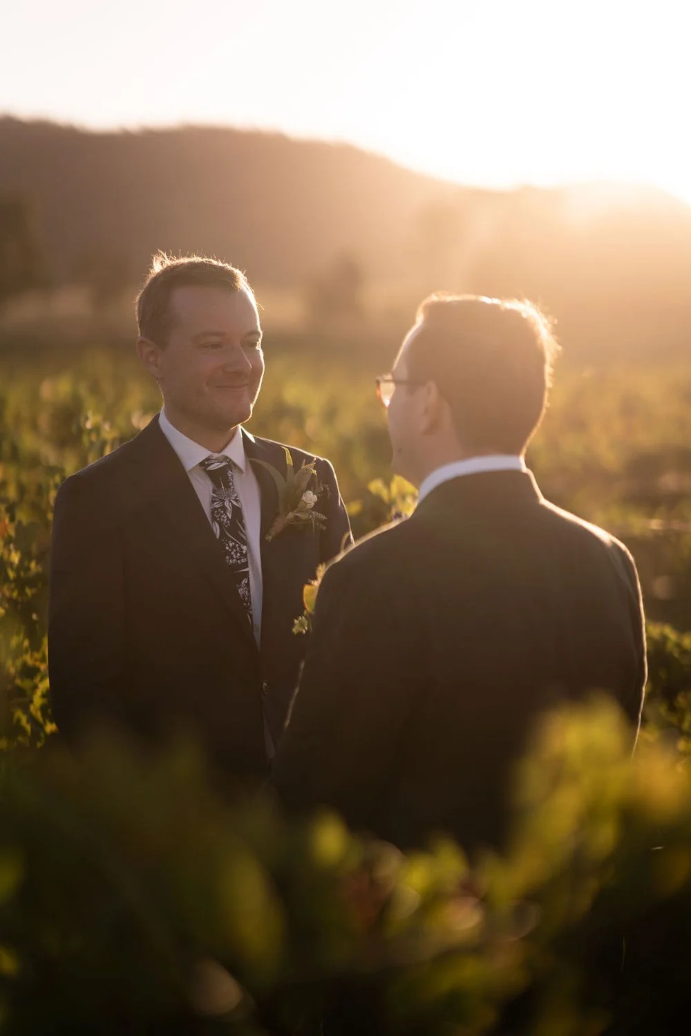 The couple backlit by the setting sun. Aaron & Scott's wedding at Margan Wines, Hunter Valley