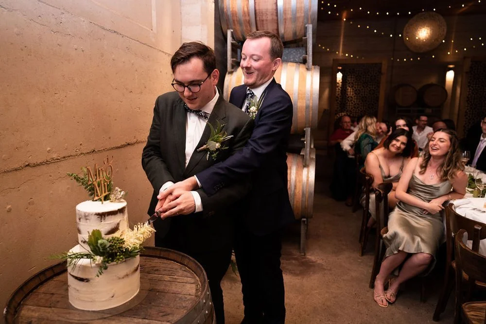 Cutting the wedding cake. Aaron & Scott's wedding at Margan Wines, Hunter Valley