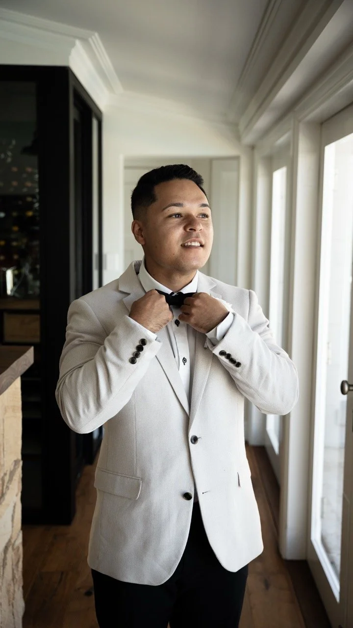 Adjusting a bow tie while getting ready. Abbey & Tyran's wedding at Hunter Valley Gardens & Kirkton Park, Hunter Valley