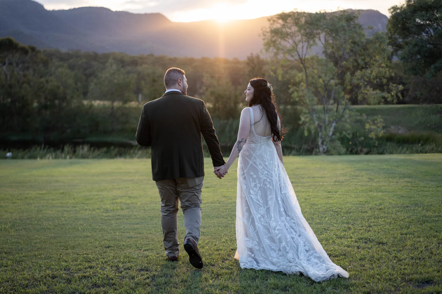 Walking across the lawn at sunset. Wedding at Peppers Creek Barrel Room & Chapel, Hunter Valley