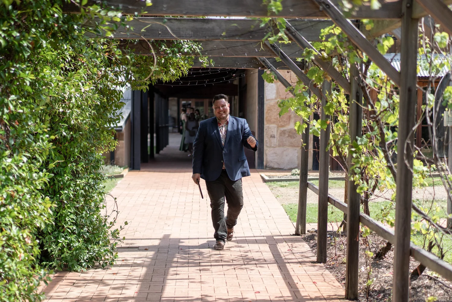 Waiting under the vine-covered walkway. Alana & Peter's wedding at Peppers Creek, Hunter Valley