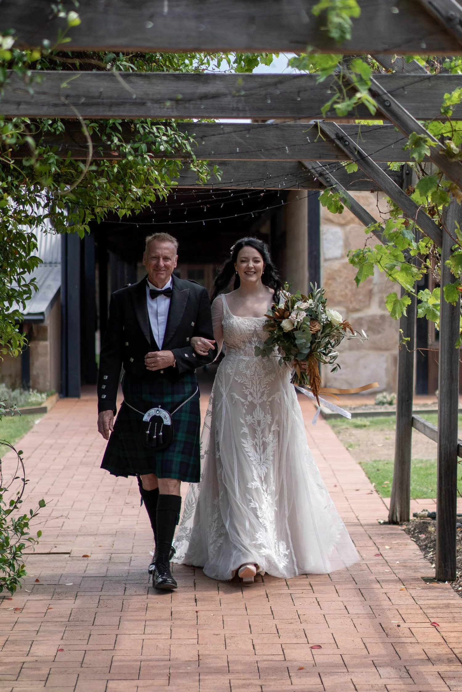 Walking down the aisle under the pergola. Wedding at Peppers Creek Barrel Room & Chapel, Hunter Valley