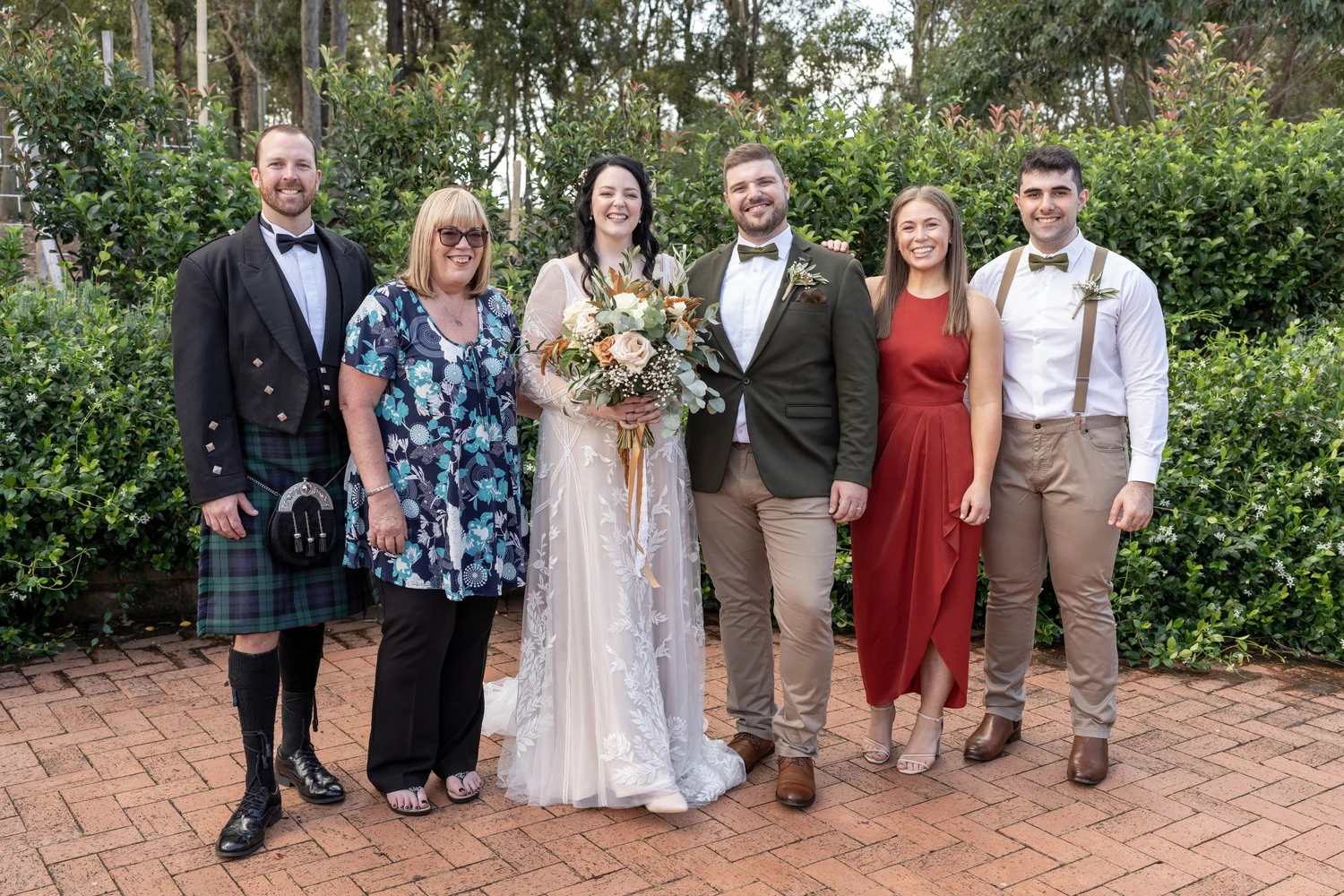Family photo on the brick terrace. Alana & Peter's wedding at Peppers Creek, Hunter Valley