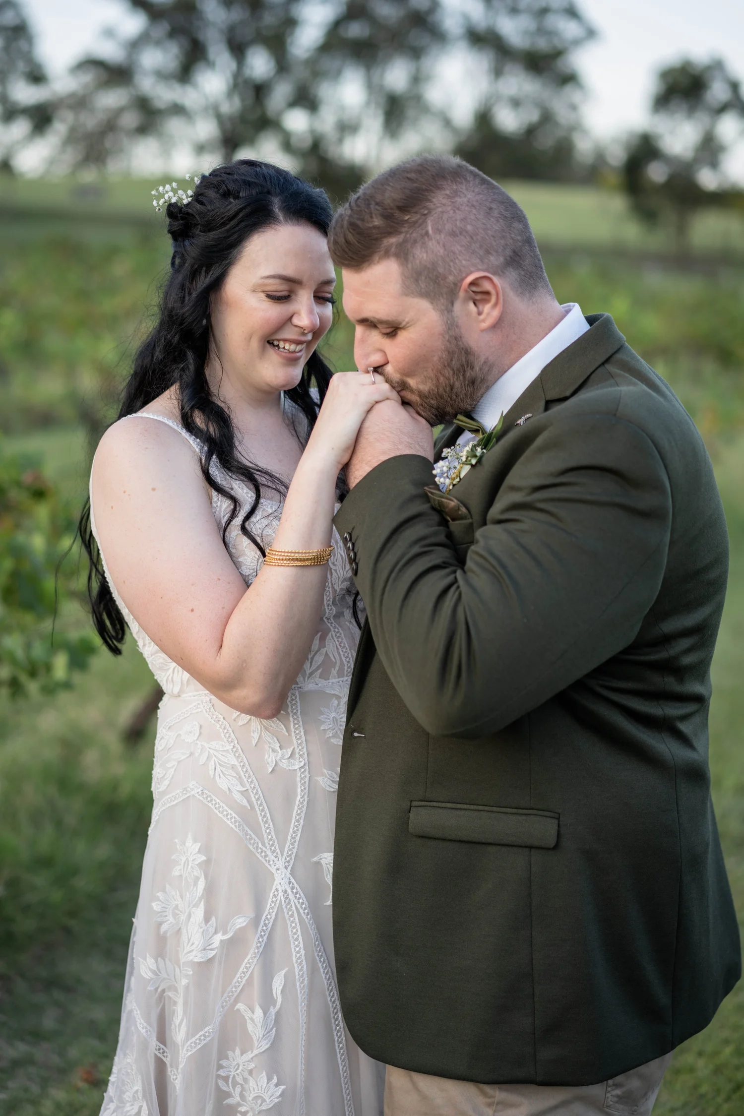 A close embrace on the lawn. Alana & Peter's wedding at Peppers Creek, Hunter Valley