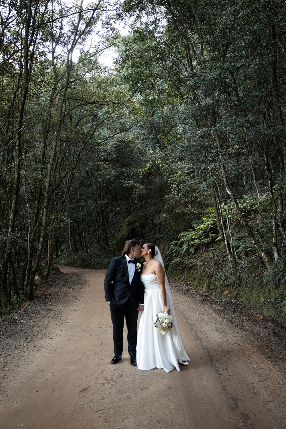Walking down the forest road. Amelia & Connor's wedding at Glenworth Valley, Central Coast