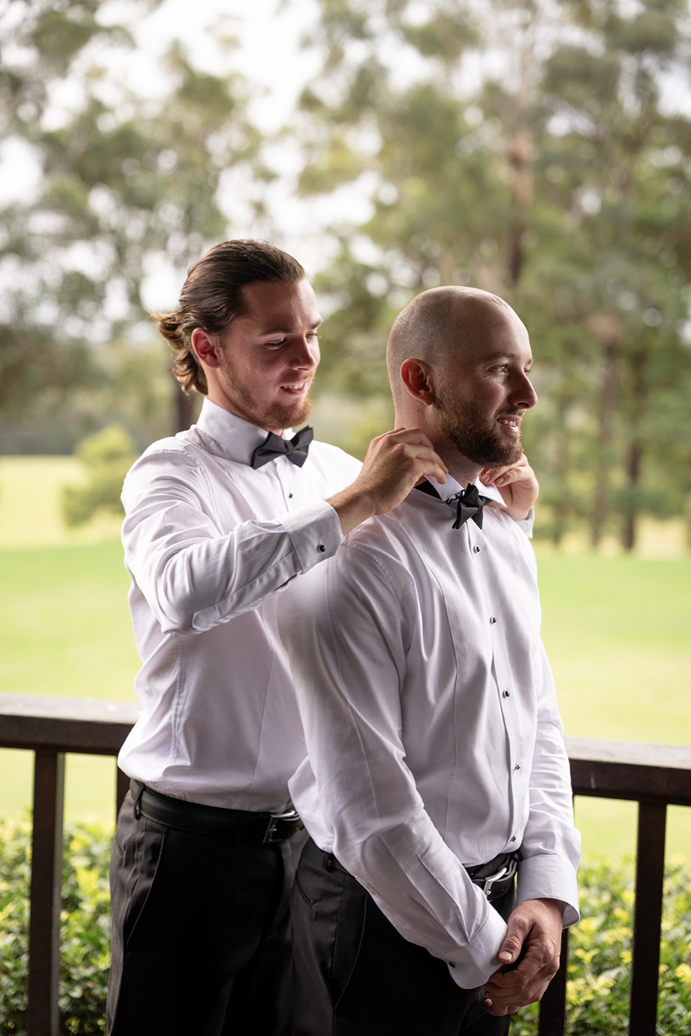 A final touch before the ceremony on the verandah. Ashley & Justin's wedding at Haven Ridge, Grants Beach, Mid North Coast