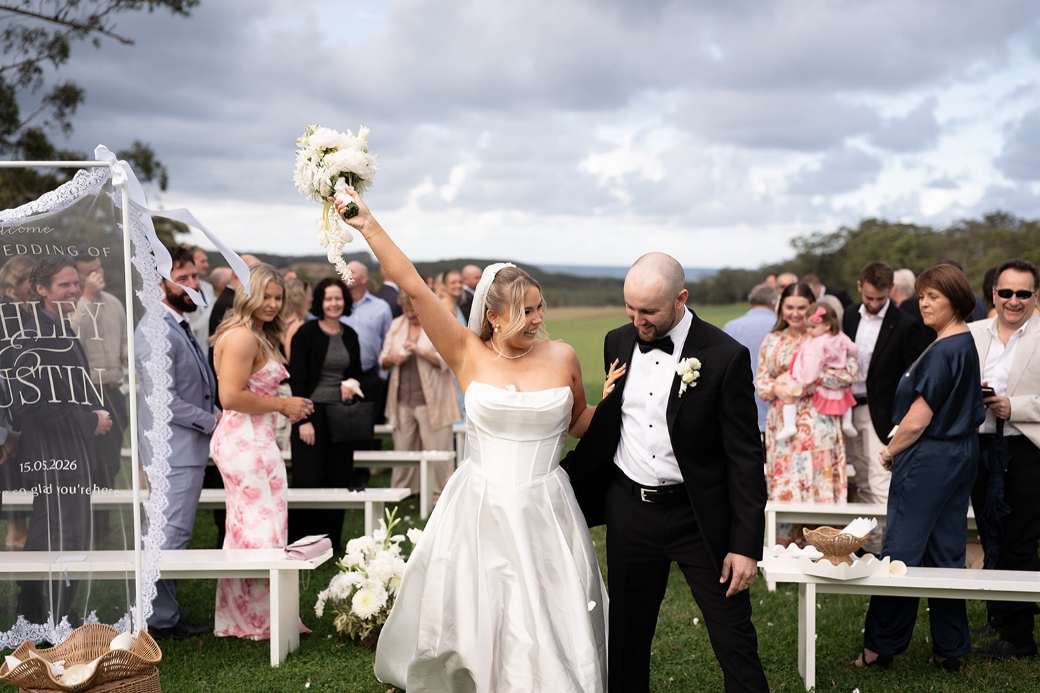 Just married, bouquet in the air. Ashley & Justin's wedding at Haven Ridge, Grants Beach, Mid North Coast