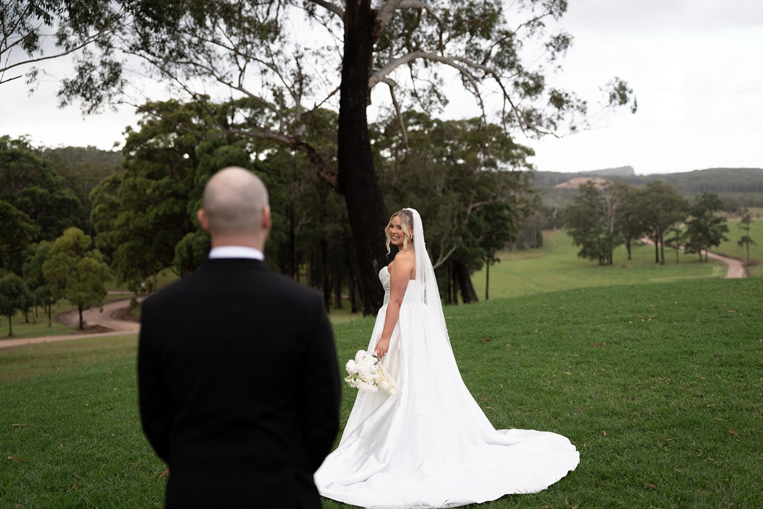 The couple looking over the valley. Ashley & Justin's wedding at Haven Ridge, Grants Beach, Mid North Coast