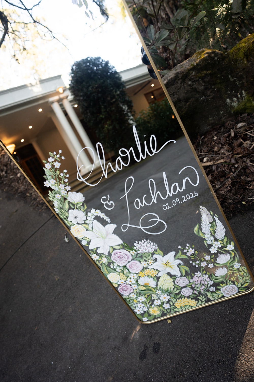 The clear welcome sign with flowers. Charlie & Lachlan's wedding at Kantara House, Central Coast