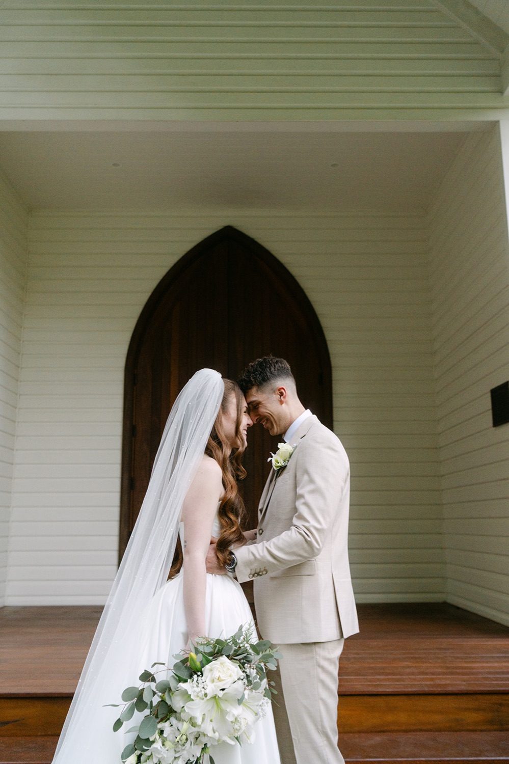 A kiss at the chapel doors. Charlie & Lachlan's wedding at Kantara House, Central Coast