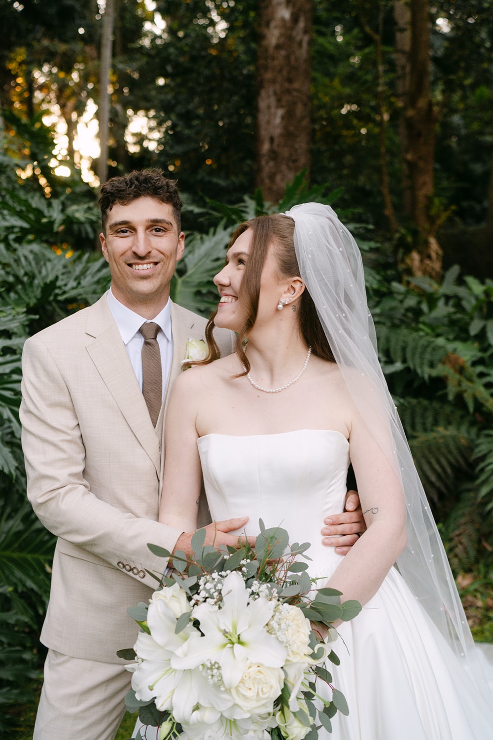 The couple laughing in the garden. Charlie & Lachlan's wedding at Kantara House, Central Coast