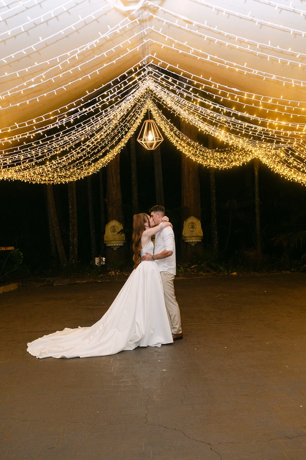 First dance under draped lights. Charlie & Lachlan's wedding at Kantara House, Central Coast
