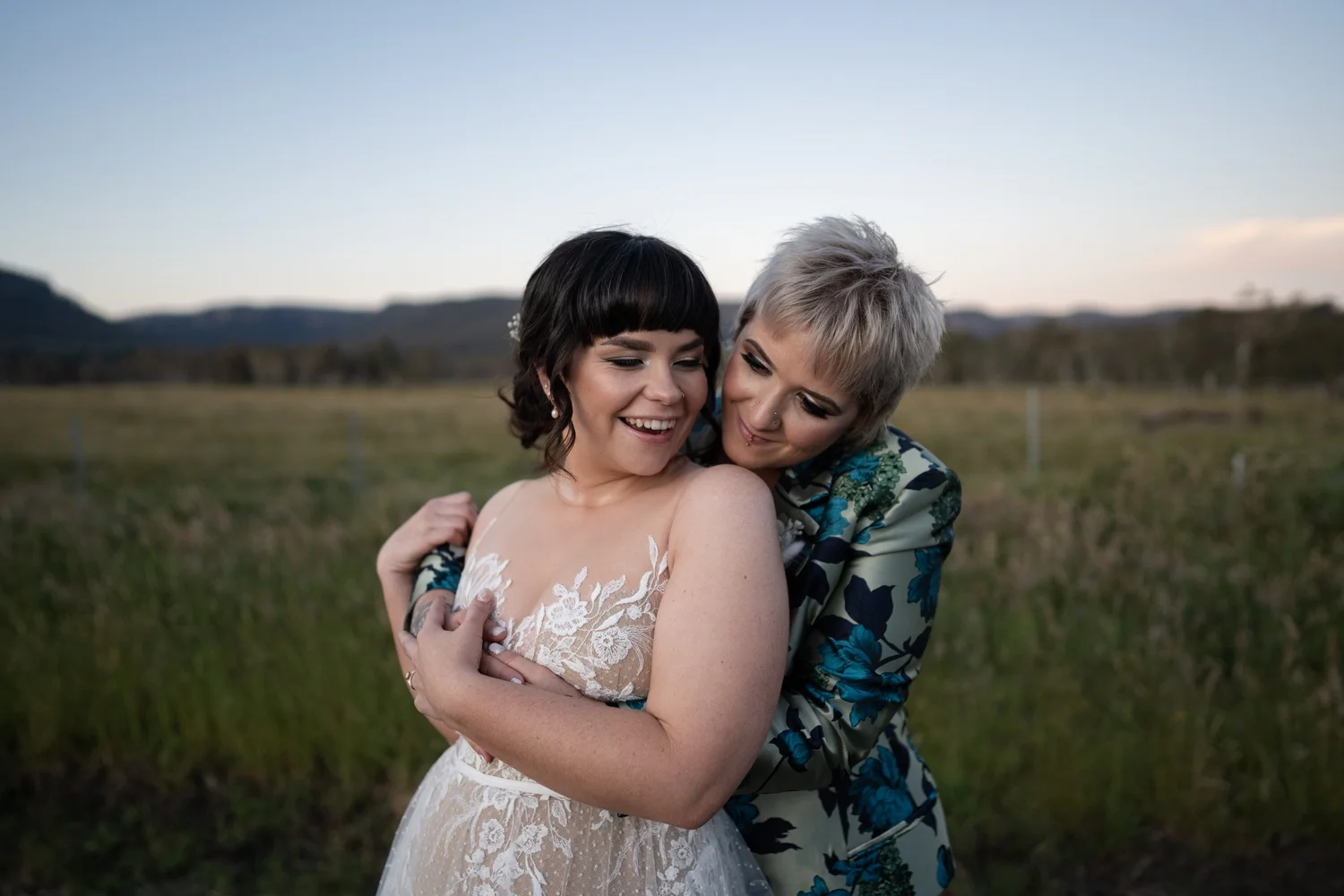 The couple embracing on a hilltop at sunset. Daena & Inez's wedding at Collits Inn, Blue Mountains