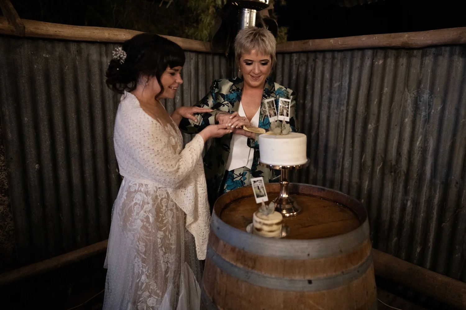 Cutting the cake on a wine barrel. Daena & Inez's wedding at Collits Inn, Blue Mountains