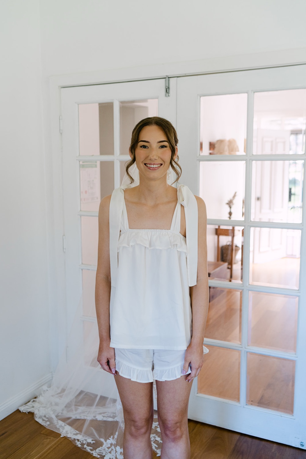 Getting ready by the French doors. Demi & Kyle's wedding at Green Cathedral, Pacific Palms, Port Stephens