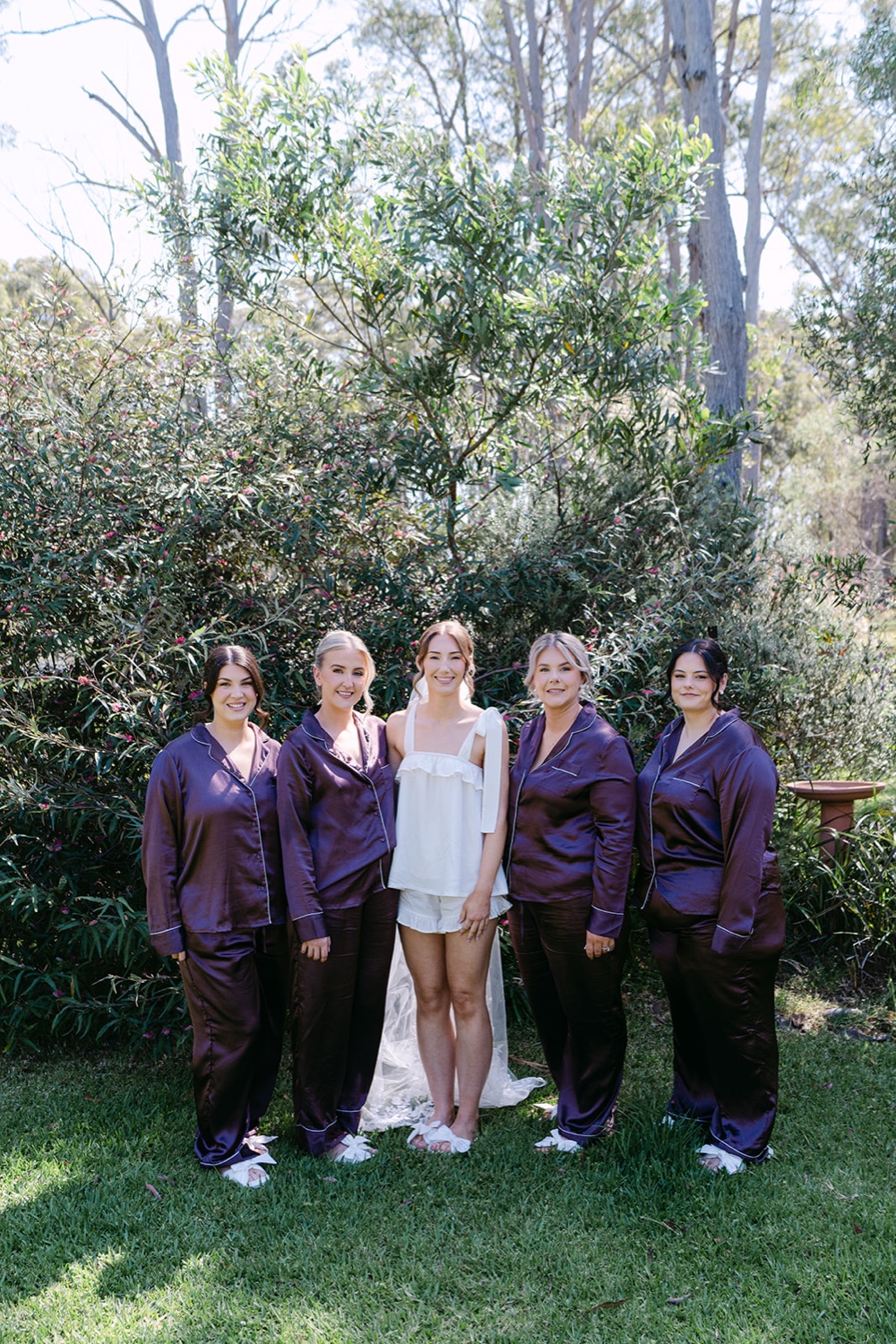 The wedding party in the garden. Demi & Kyle's wedding at Green Cathedral, Pacific Palms, Port Stephens