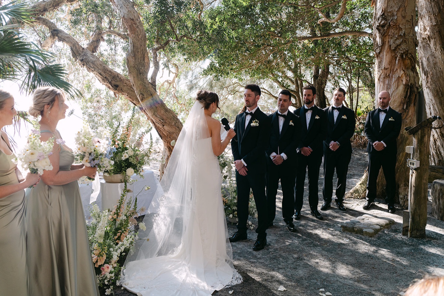 The ceremony under the palms at the Green Cathedral. Demi & Kyle's wedding at Green Cathedral, Pacific Palms, Port Stephens