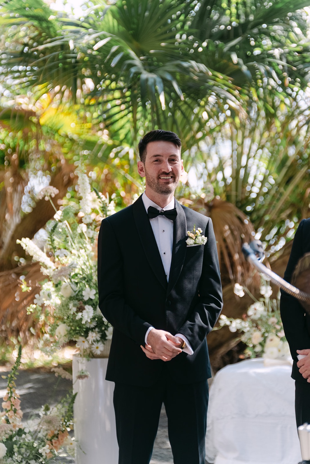 Waiting for the ceremony under the palms. Demi & Kyle's wedding at Green Cathedral, Pacific Palms, Port Stephens
