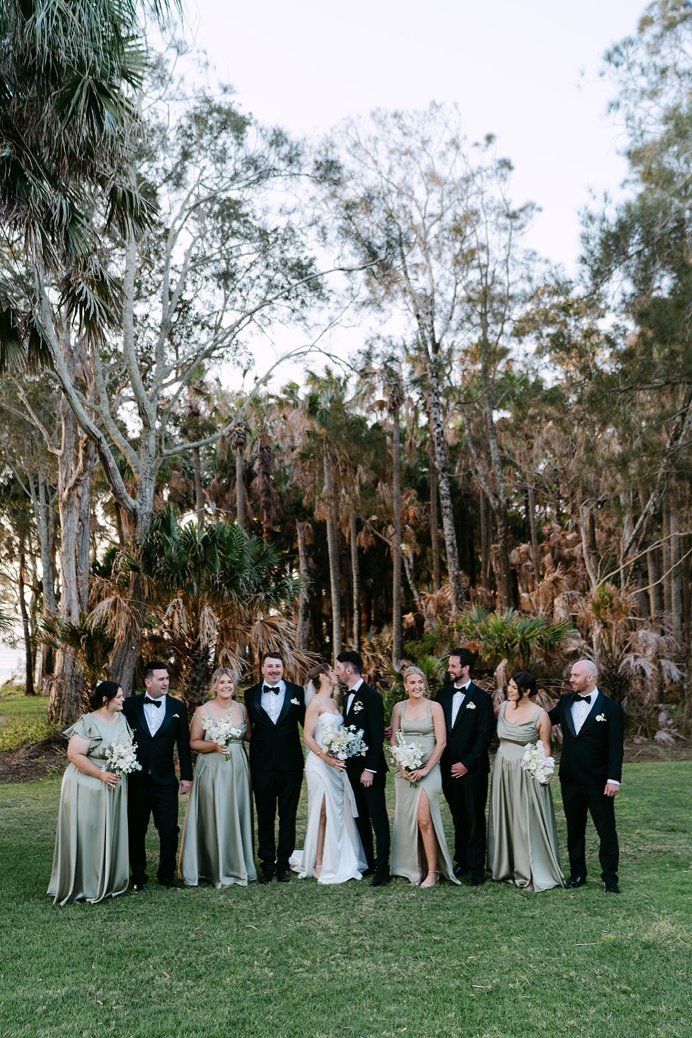 The wedding party under a big tree. Demi & Kyle's wedding at Green Cathedral, Pacific Palms, Port Stephens