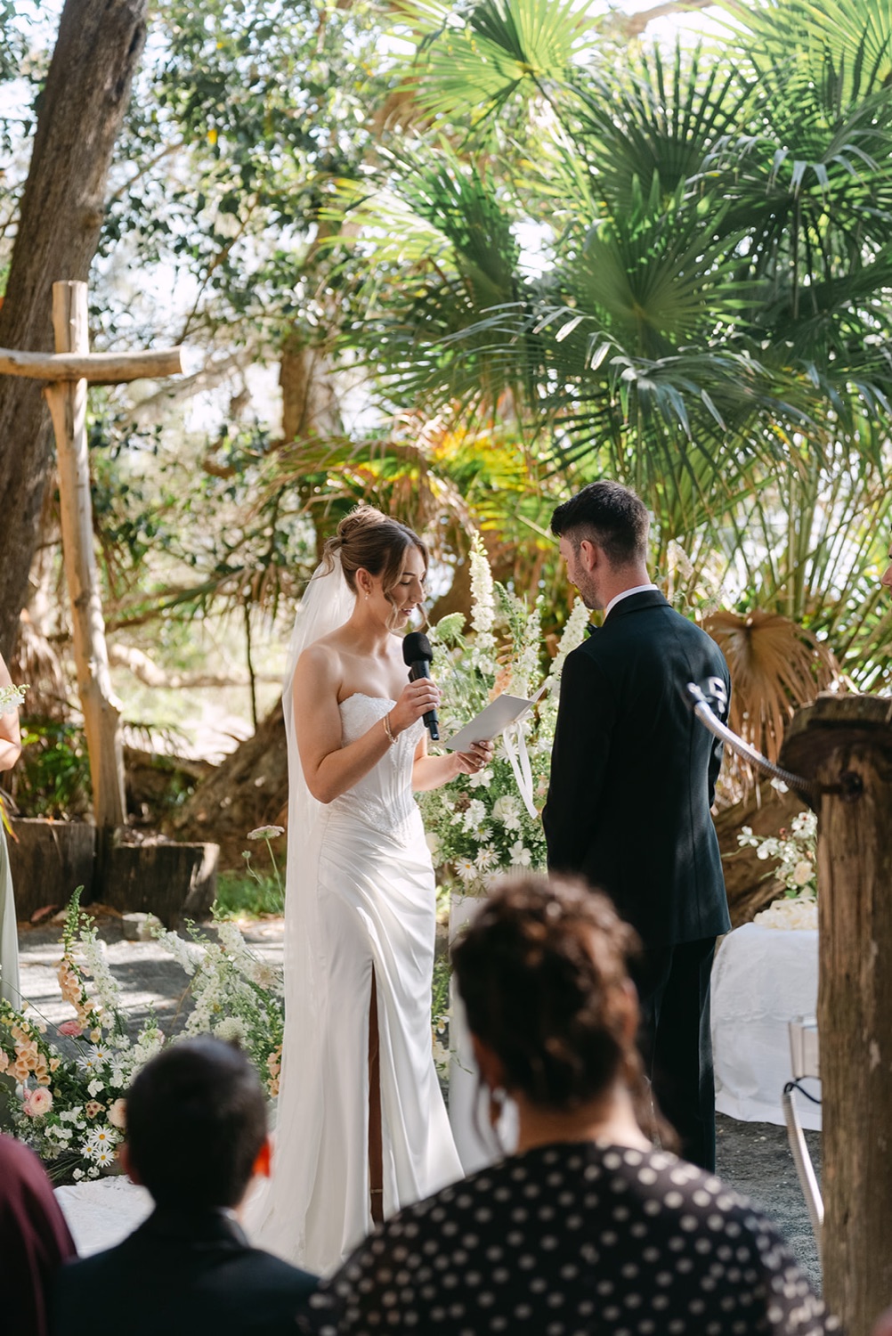 The ceremony seen from the guests. Demi & Kyle's wedding at Green Cathedral, Pacific Palms, Port Stephens