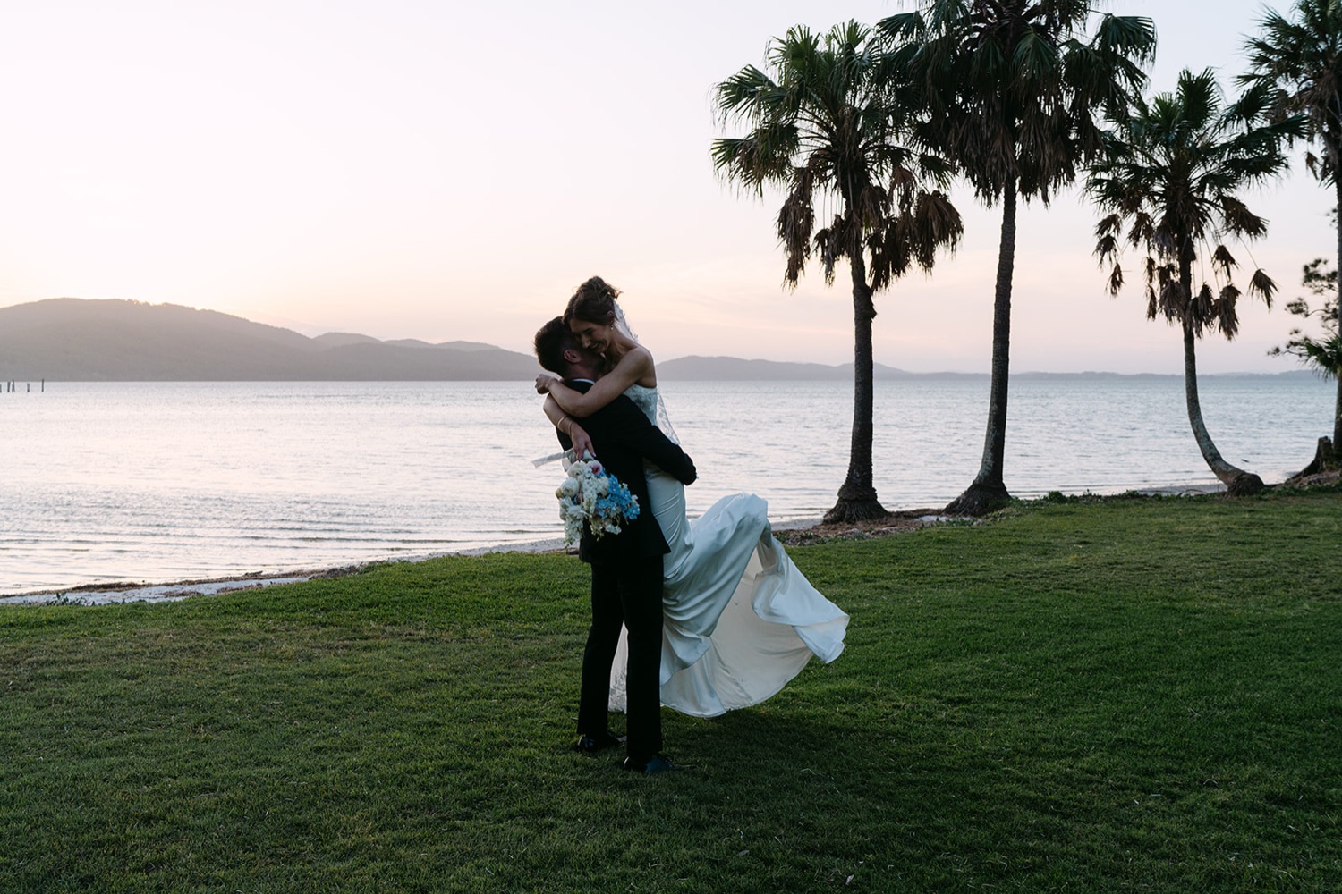 A spin on the lakeside lawn. Demi & Kyle's wedding at Green Cathedral, Pacific Palms, Port Stephens