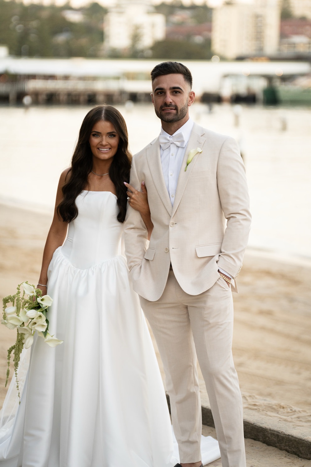 The couple by the water at Manly Cove. Georgia & Kyle's wedding at Manly Pavilion, Sydney