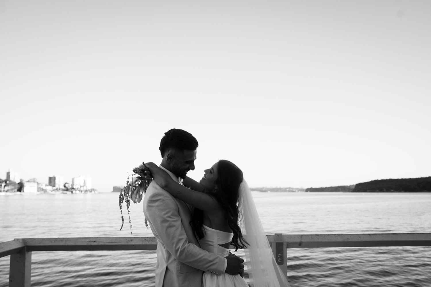 A kiss by the harbour, in black and white. Georgia & Kyle's wedding at Manly Pavilion, Sydney