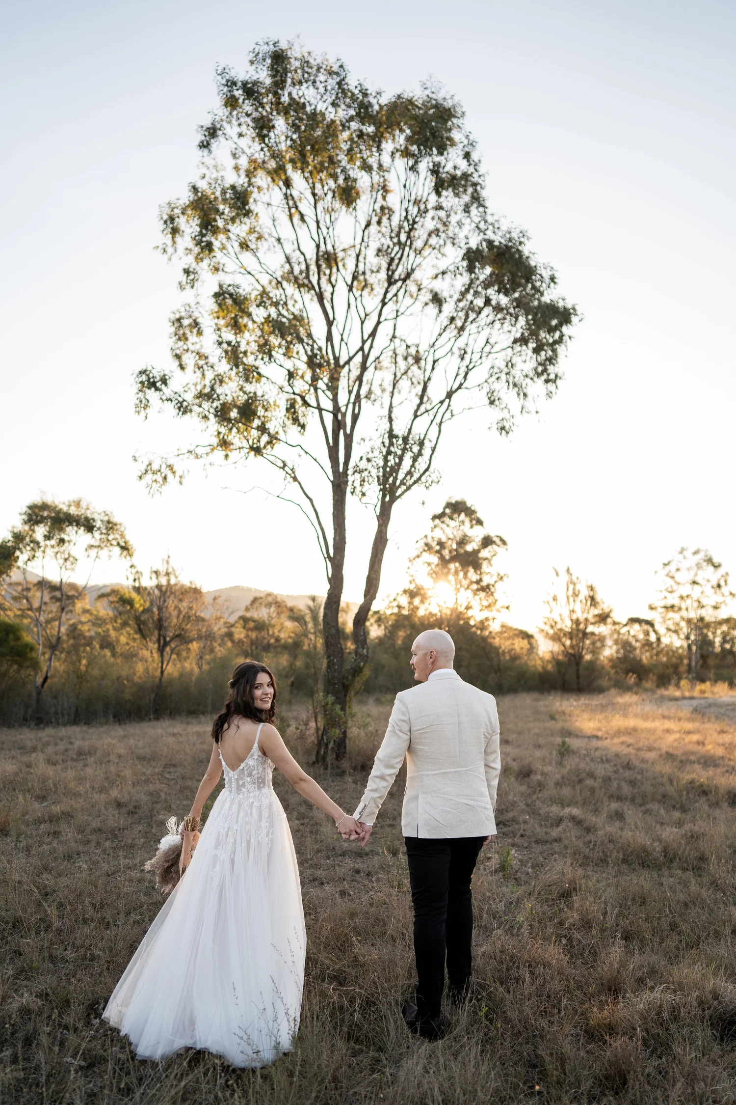 The couple under a gum tree in the paddock. Grace & Rhys's wedding at Marlu Station, Hunter Valley