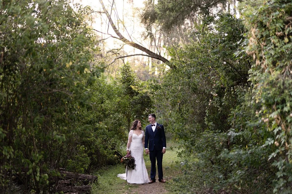 Walking down a leafy garden path. Grace & Shannon's wedding at All Saints Chapel, Woodville, Hunter Valley