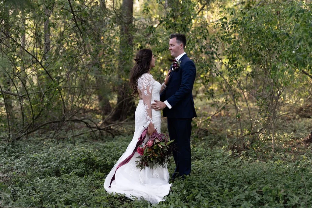 The couple among the trees. Grace & Shannon's wedding at All Saints Chapel, Woodville, Hunter Valley