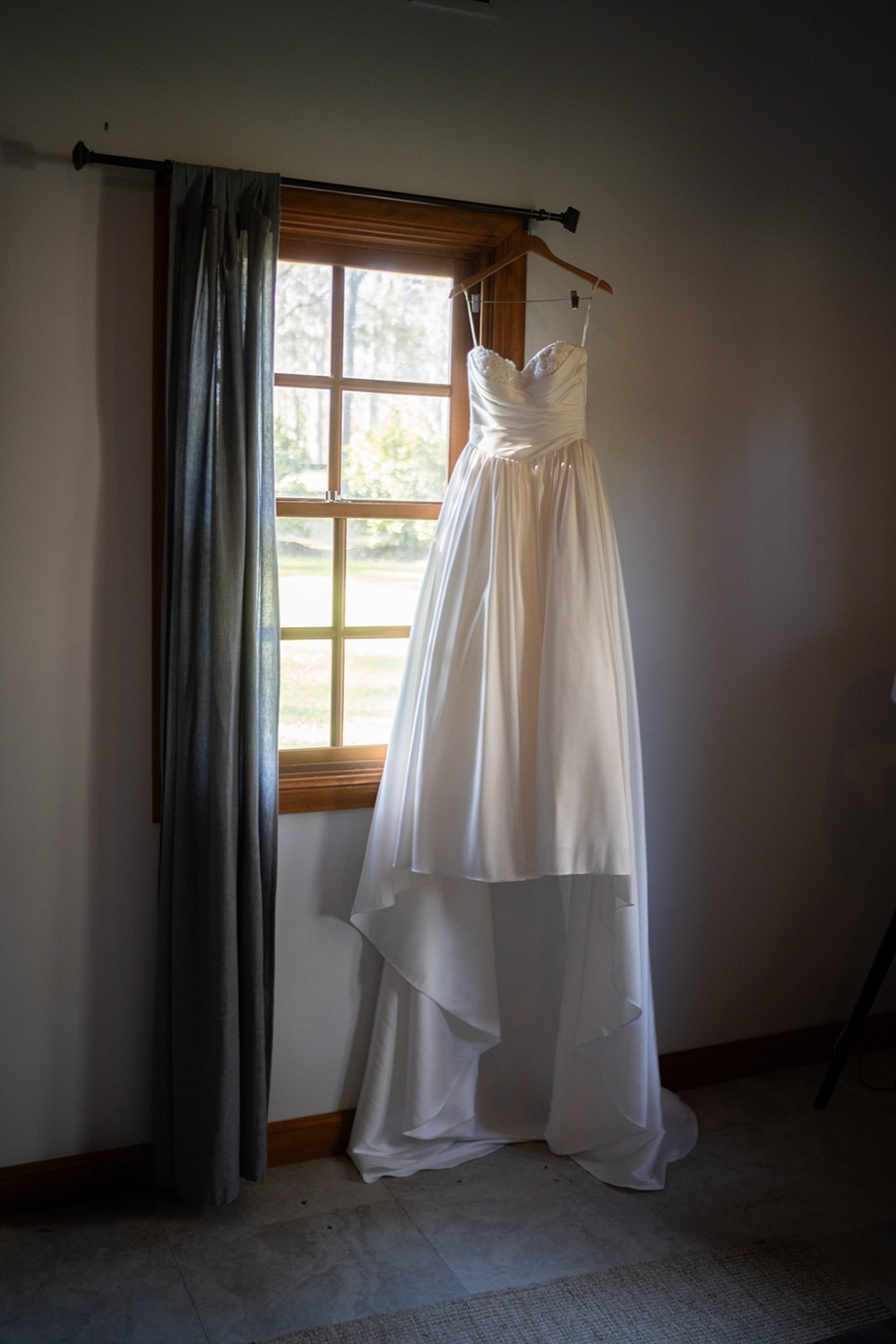 The wedding dress hanging in the window. Isabelle & Aidan's wedding at Enzo, Hunter Valley