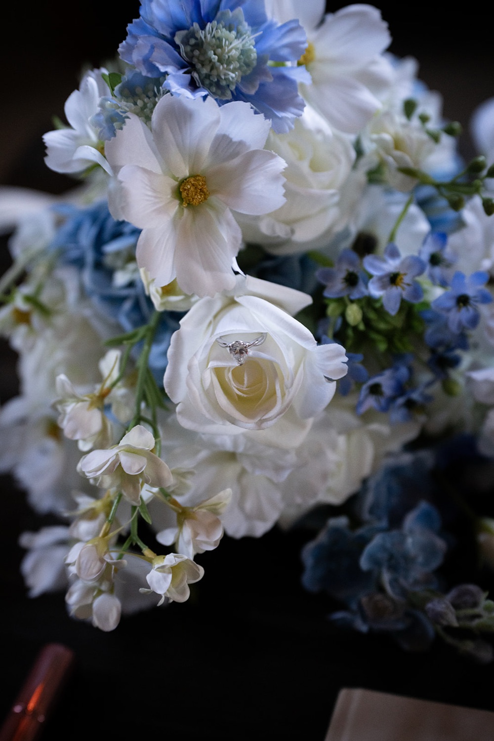 A bouquet of white roses and blue flowers. Isabelle & Aidan's wedding at Enzo, Hunter Valley