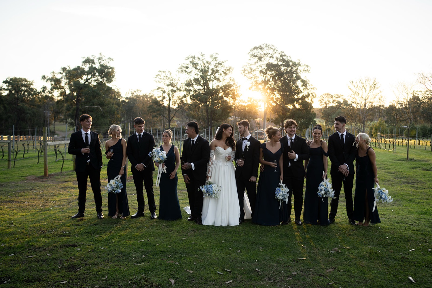 The wedding party in the vineyard at sunset. Isabelle & Aidan's wedding at Enzo, Hunter Valley