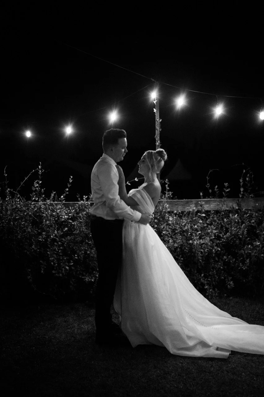 Portrait under the night lights, in black and white. Jamie & Corey's wedding at Squire’s Vineyard, Hunter Valley