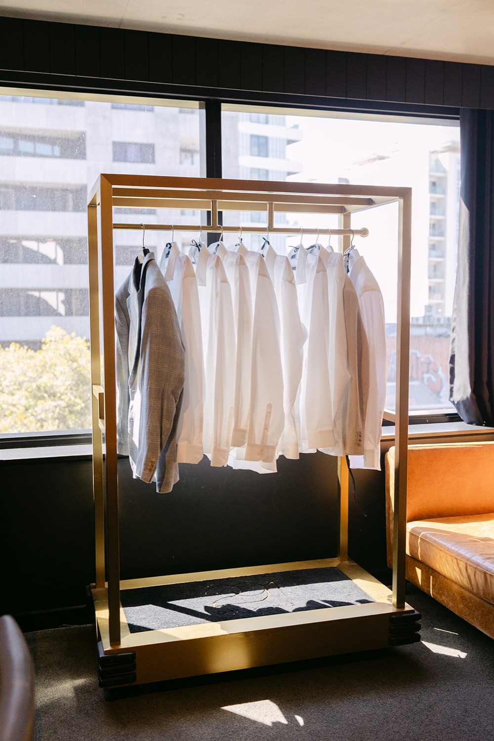 Suits hanging in the hotel room. Jasmin & Jye's wedding at Merewether Surfhouse & Ocean Baths, Newcastle