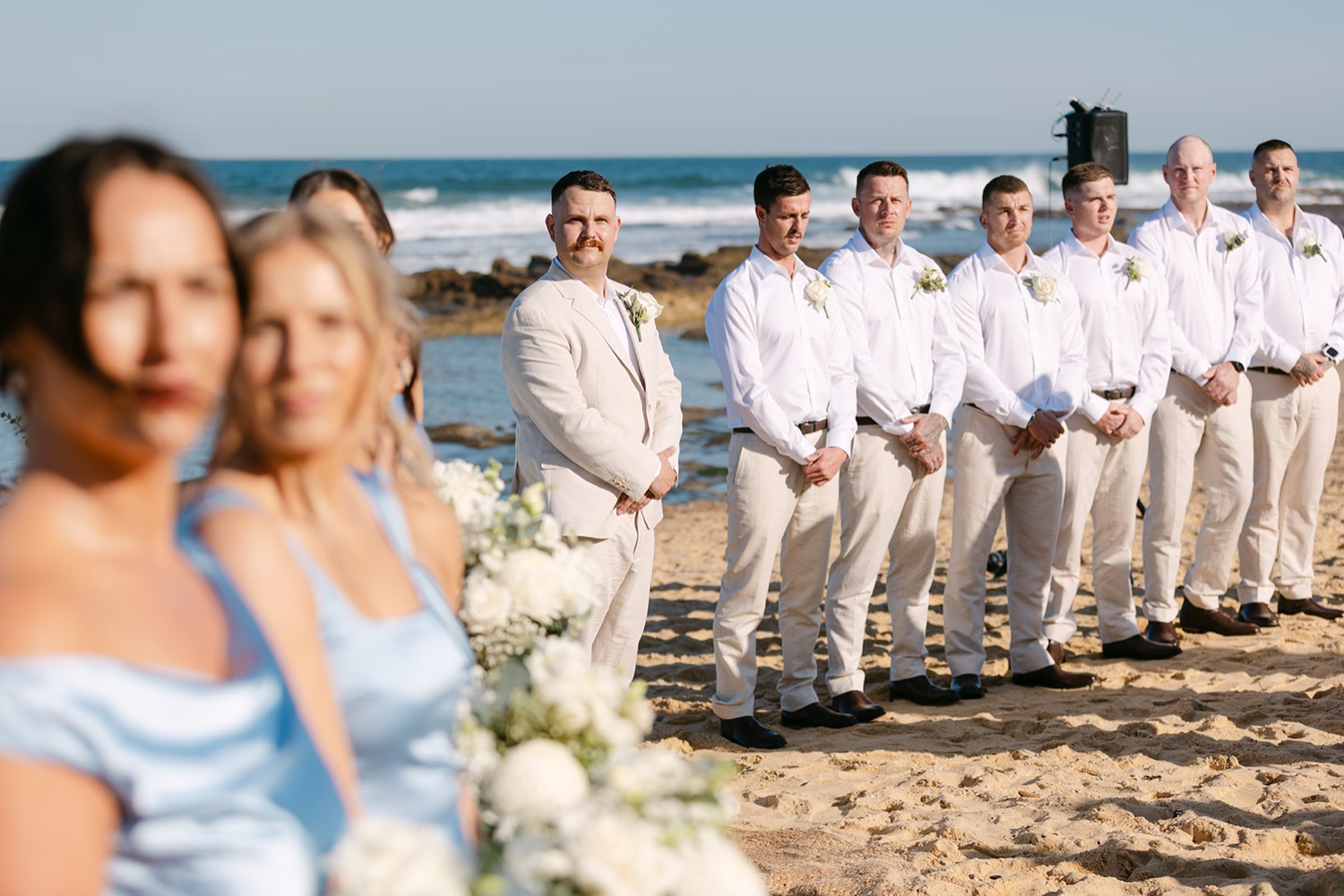 The ceremony on the beach. Jasmin & Jye's wedding at Merewether Surfhouse & Ocean Baths, Newcastle