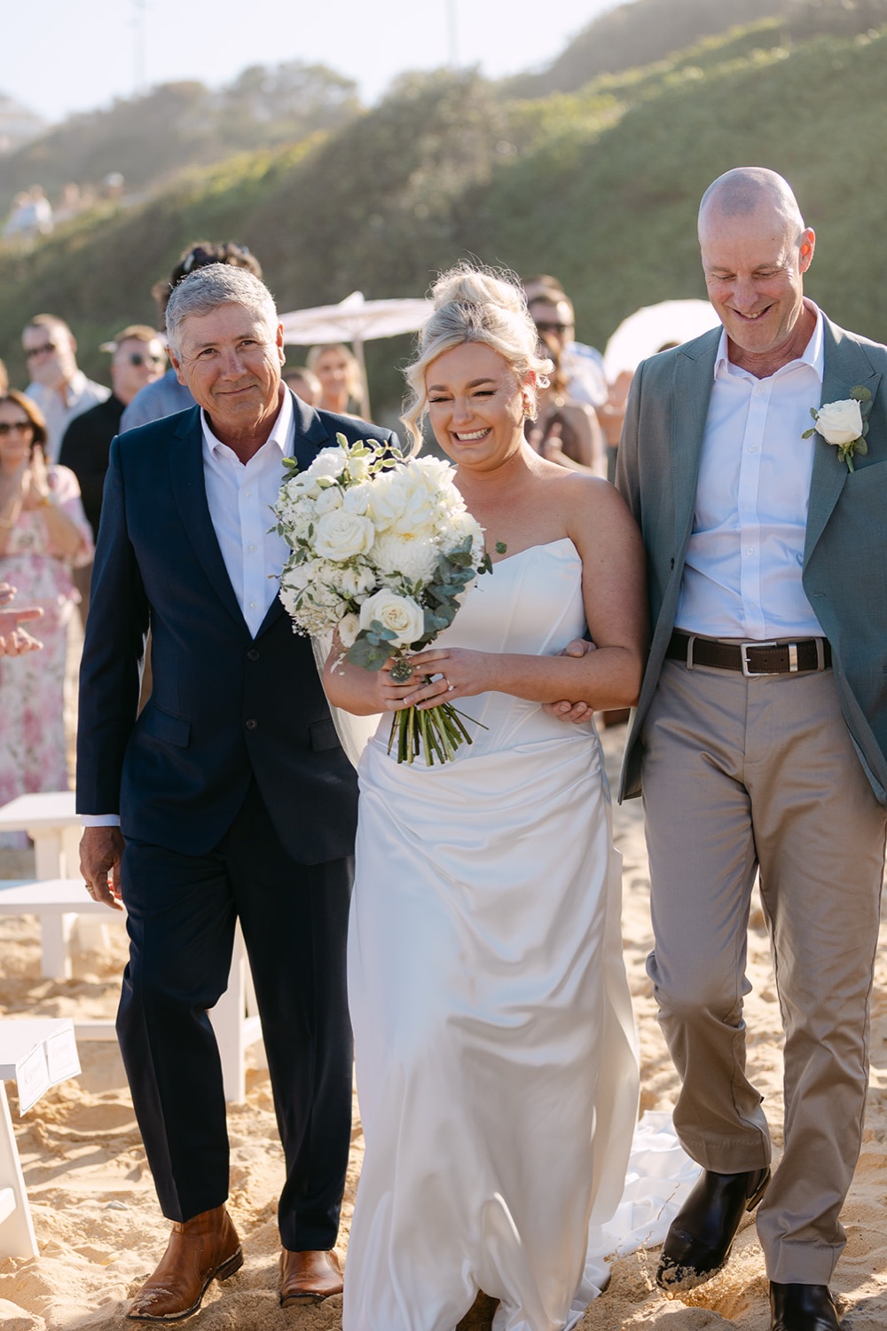 Walking down the aisle on the sand. Jasmin & Jye's wedding at Merewether Surfhouse & Ocean Baths, Newcastle